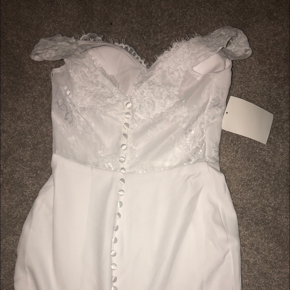 Elegant white lace dress for special occasion.